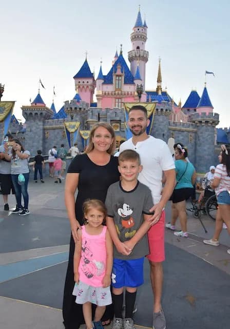 Travelers in front of Sleeping Beauty Castle at Disneyland